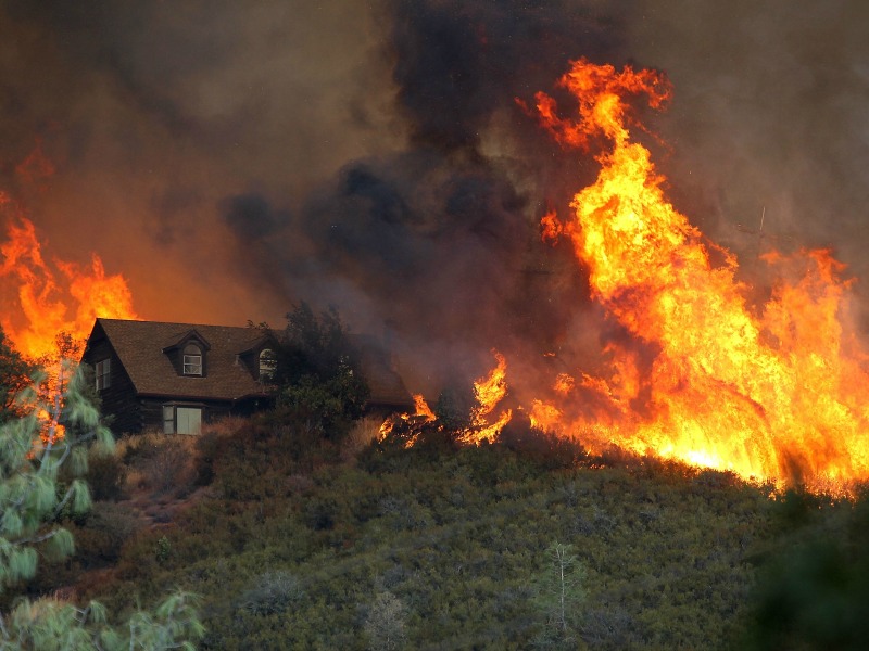 LOWER LAKE, CA - JULY 31:  A firefighting helicopter drops water on spot fires while battling the Rocky Fire on July 31, 2015 in Lower Lake, California. Over 900 firefighters are battling the Rocky Fire that erupted to over 15,000 acres since it started on Wednesday afternoon. The fire is currently five percent contained and has destroyed 3 homes.  (Photo by Justin Sullivan/Getty Images)